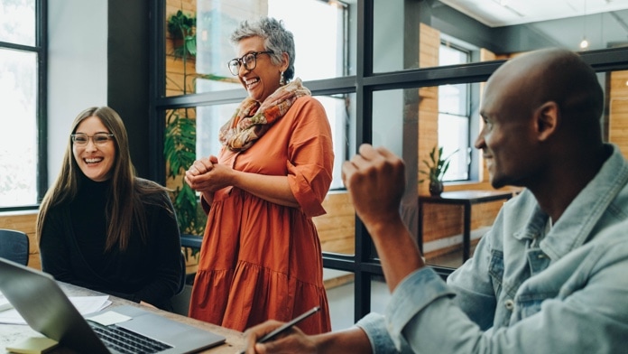 Diverse businesspeople smiling cheerfully during an office meeting