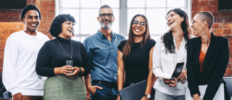 Happy group of businesspeople laughing in an office