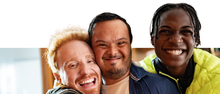 A disabled young man and his two friends smiling