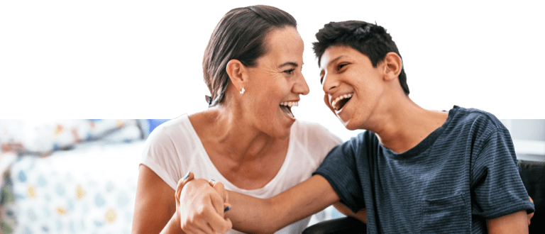 Caregiver and special kid smiling
